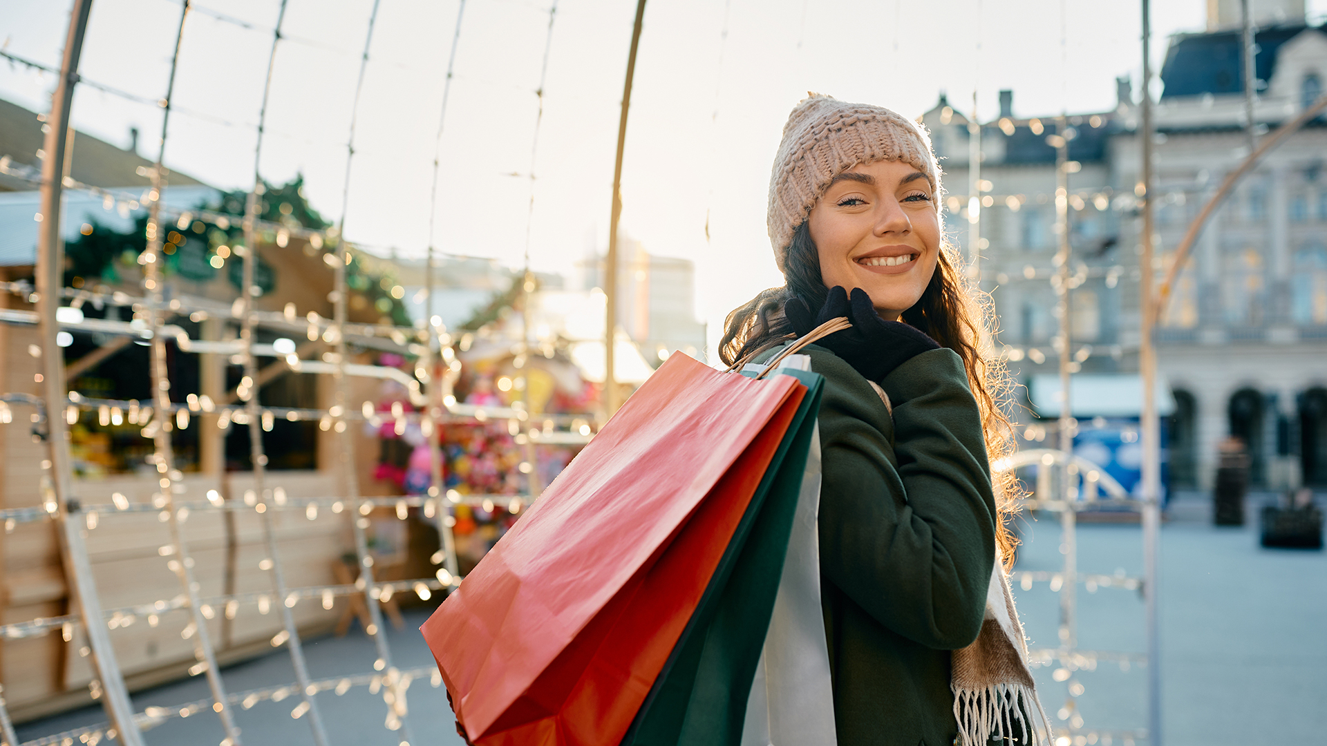 Eine Frau auf dem Weihnachtsmarkt mit Einkaufstüten in der Hand